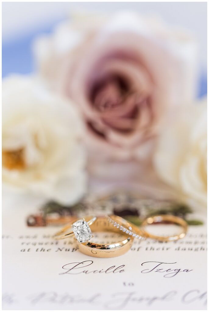 four wedding rings on a wedding invitation