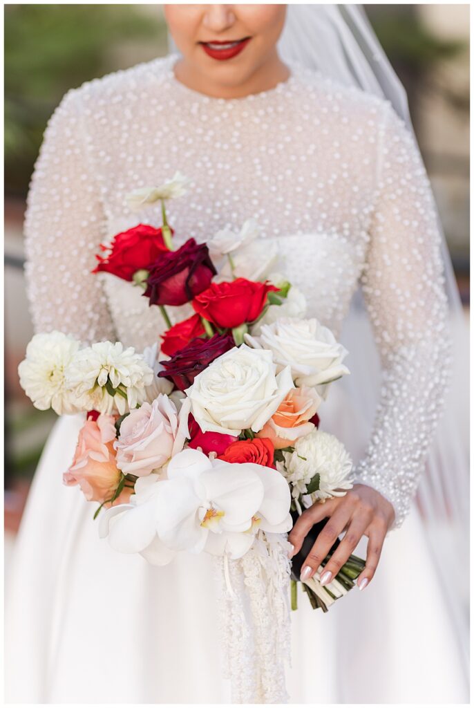 bride with her red and white bouquet