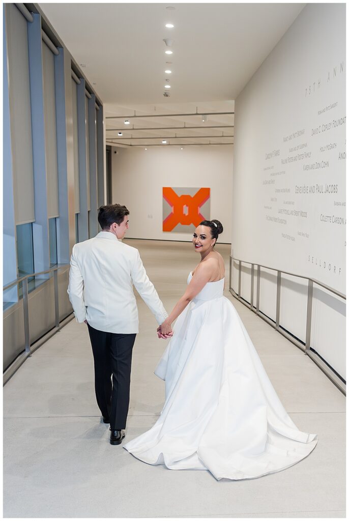 bride and groom walking through the museum  at their Museum of Contemporary Arts San Diego Wedding