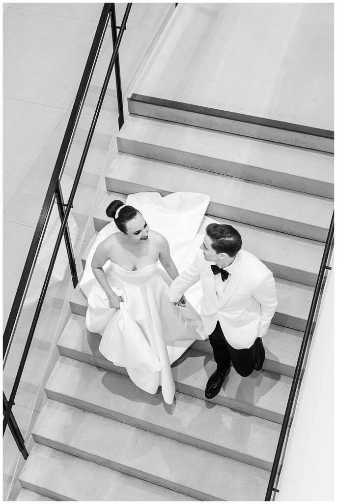 bride and groom on the stairs  at their Museum of Contemporary Arts San Diego Wedding
