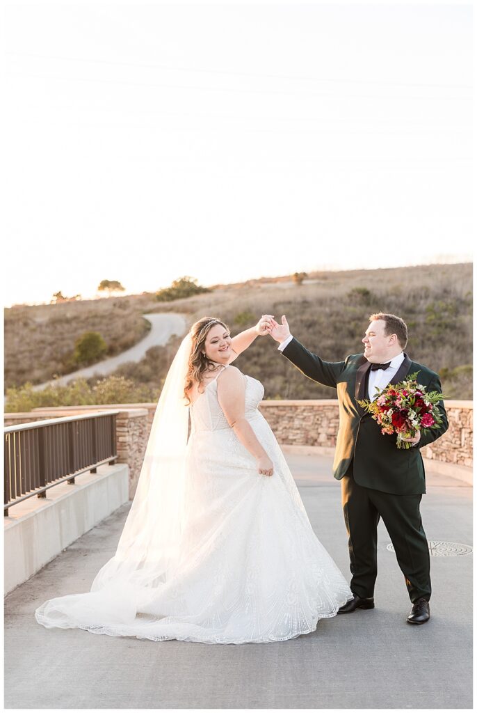 Bride and Groom twirling on the bridge at The Crossings at Carlsbad San Diego