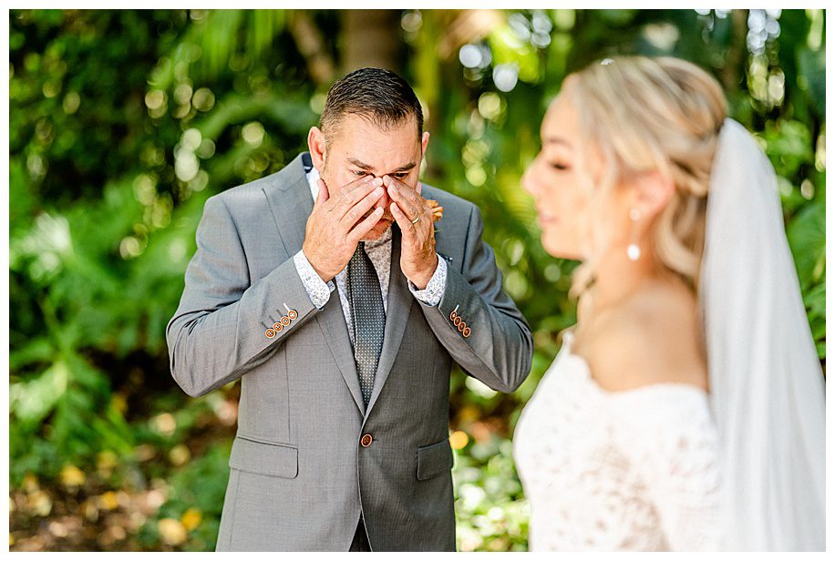father crying while looking at daughter for first look