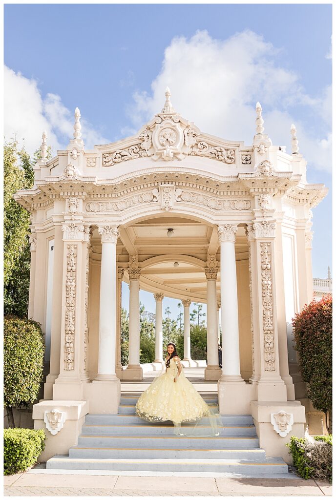 Girl celebrating her quinceanera in yellow dress at the Organ Pavilion in Balboa Park, San Diego