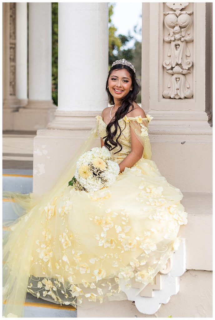 Teen girl in yellow quinceanera dress at the Organ Pavilion in Balboa Park, San Diego