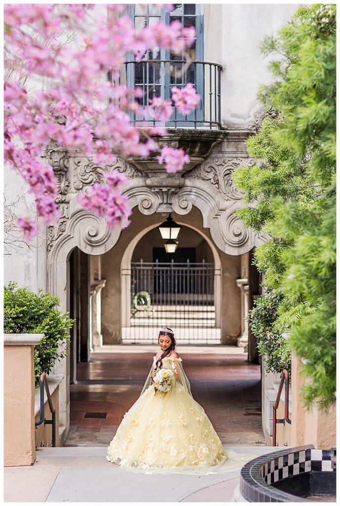 Balboa Park Quinceanera portrait of young girl in yellow dress by the Museum of Us, San Diego