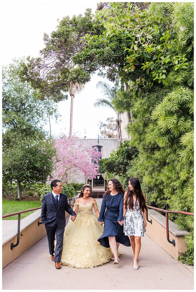 Family walking in Balboa Park, San Diego for a quinceanera photo session
