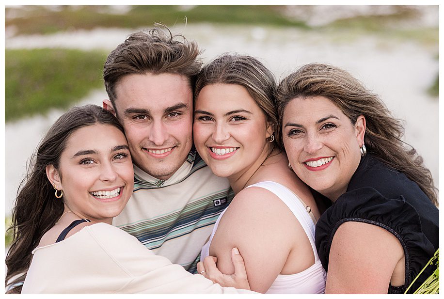 family of four hugging