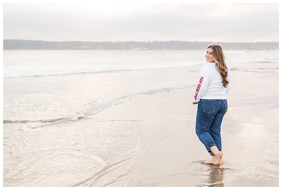 Teen girl walking away on beach in Coronado Beach
