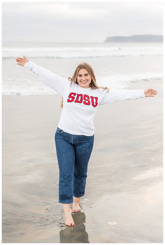Teen girl in San Diego State sweatshirt on beach in. Coronado