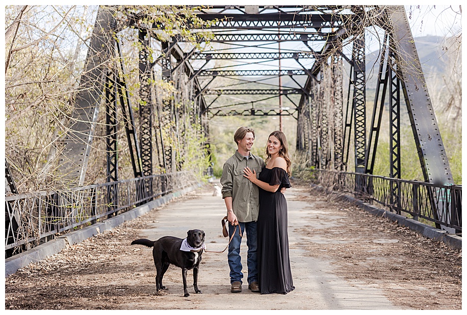 engaged couple walking their dog on the Sweetwater River Bridge