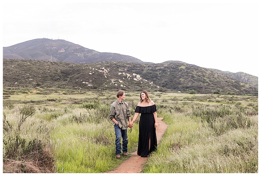 couple walking down path in an open field in San Diego