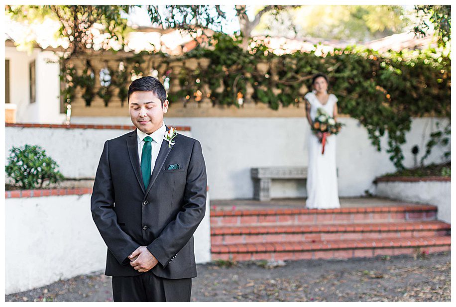 Bride walking up behind groom at their first look during their San Diego Wedding