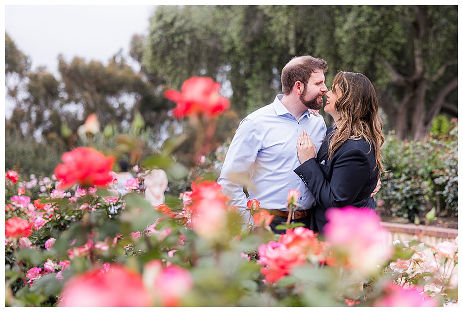 couple kissing in rose garden during their Engagement Session at Balboa Park 