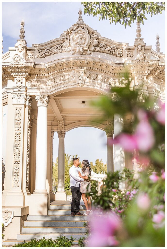 couple hugging in Organ Pavilion at their San Diego Balboa park engagement session