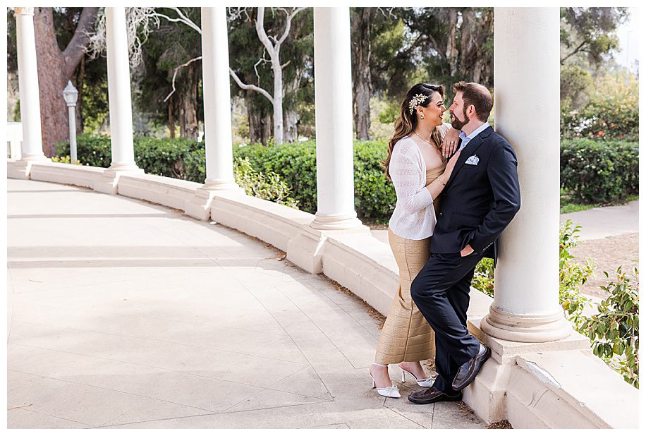 couple leaning against a pillar at the organ pavilion at Balboa Park San Diego