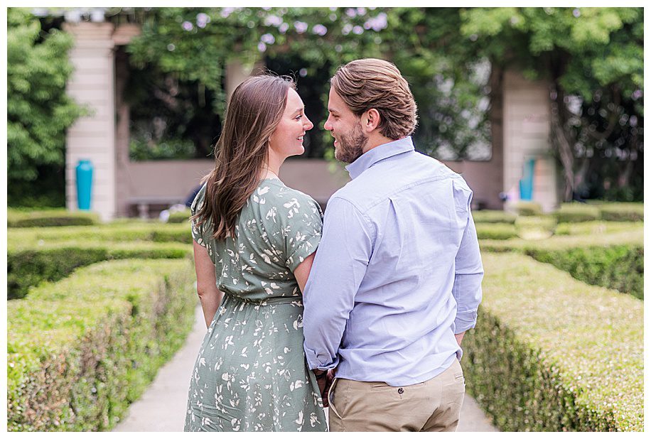 Couple gazing at each other in garden in San Diego engagement session