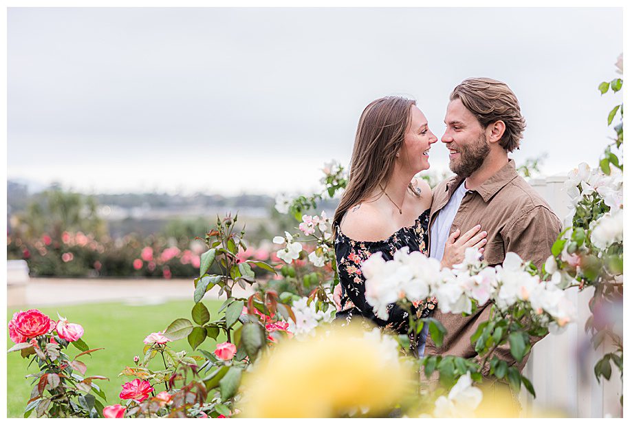 Couple in rose garden at engagement session at Balboa Park