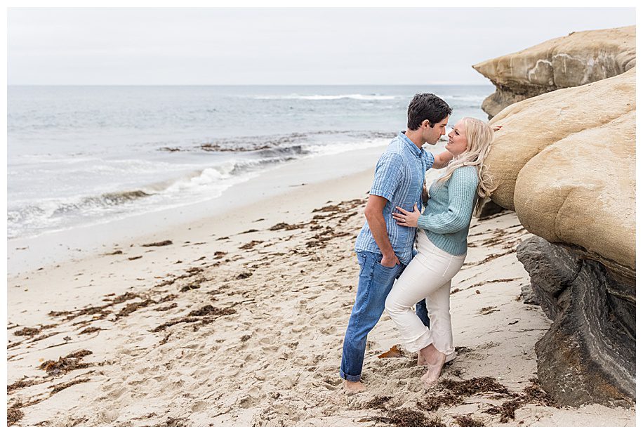 couple leaning against rock at their San Diego Engagement Session