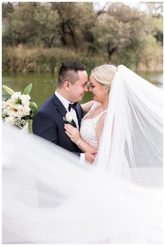 WestWynd Ranch Wedding bride and groom hugging and veil flying