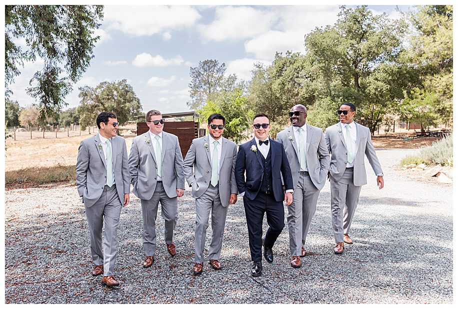 groom and groomsen walkiing at a WestWynd Ranch Wedding