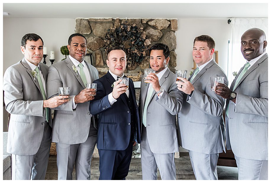 groom and groomsmen toasting