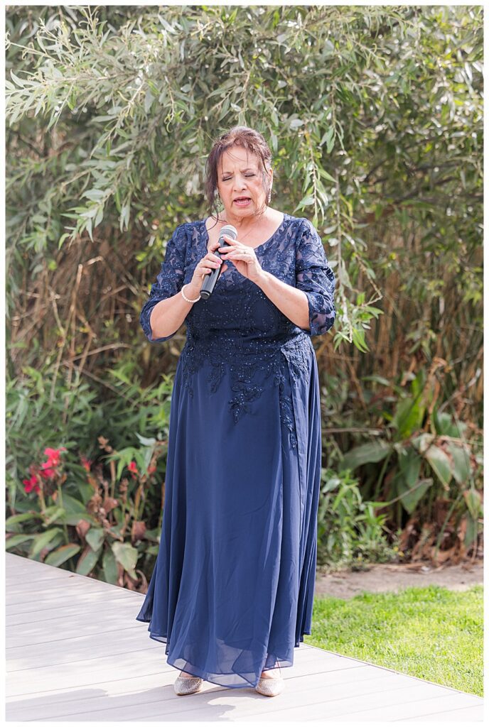 mother of the groom singing during wedding ceremony