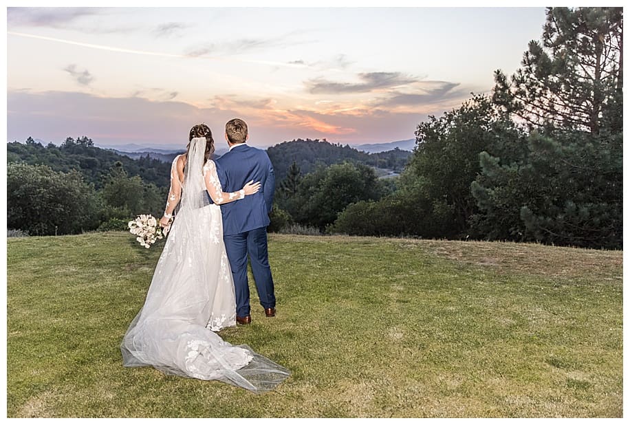 bride and groom looking at sunset at their Sacred Mountain Wedding
