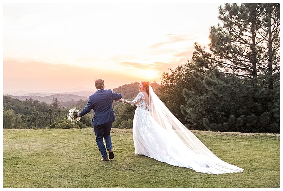 bride and groom walking at Sacred Mountain Wedding at sunset