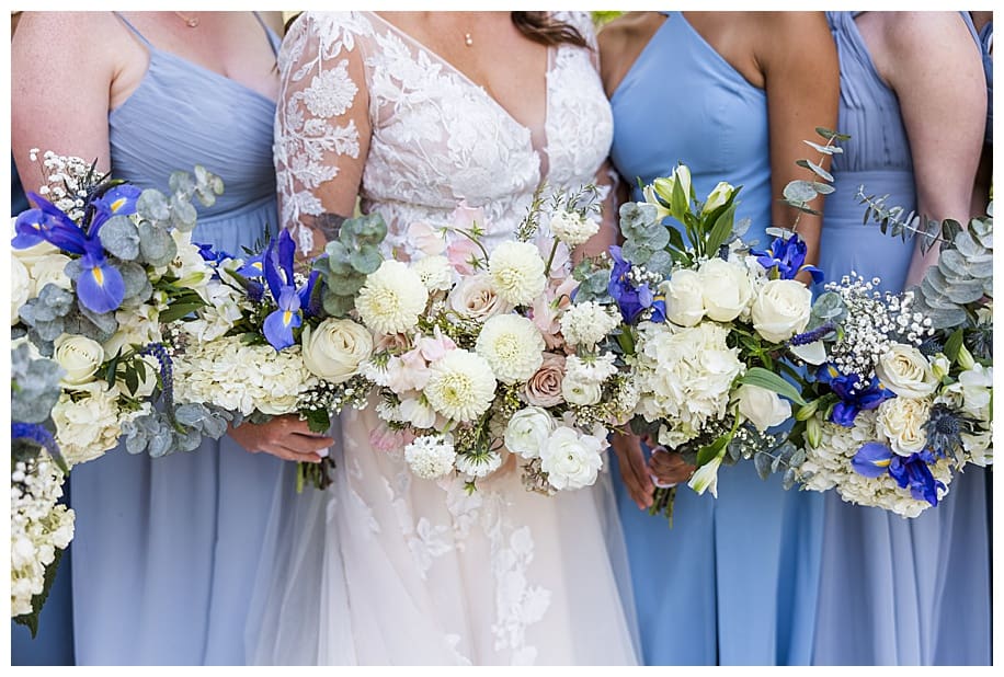 bride and bridesmaids in blue dress with bouquets