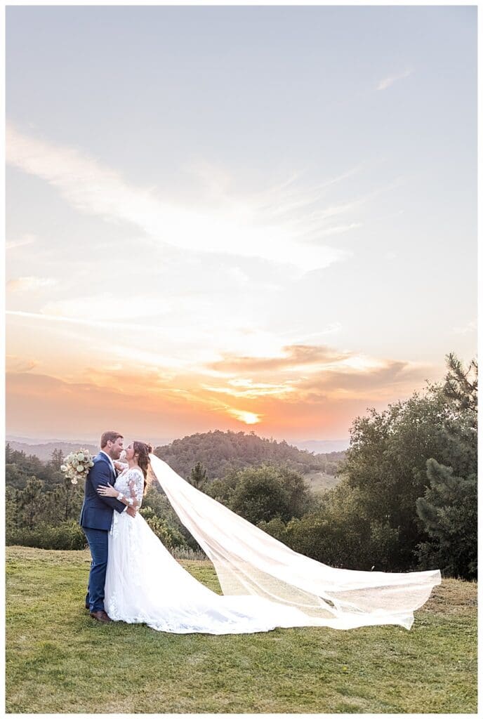 bride and groom hugging at sunset at their Sacred Mountain Wedding