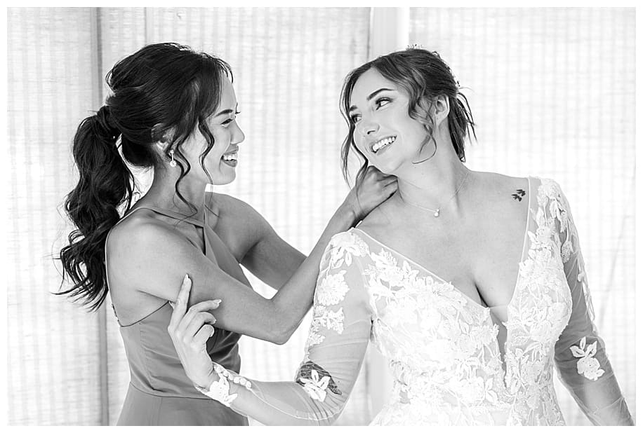 bride and maid of honor laughing