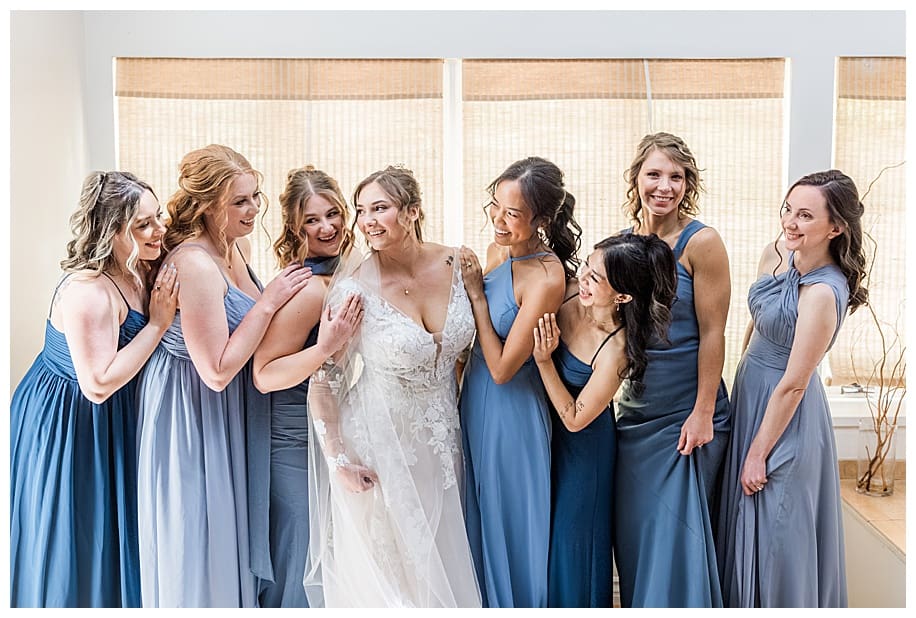 bride and bridesmaids hugging and smiling