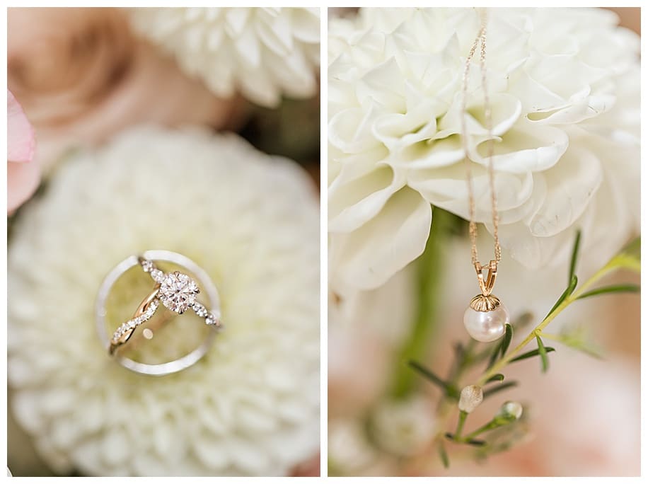 wedding rings and pearl necklace on white flowers