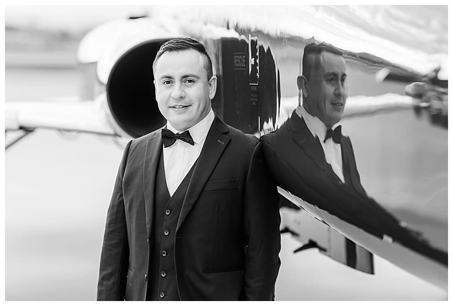 groom by jet fighter for portrait session