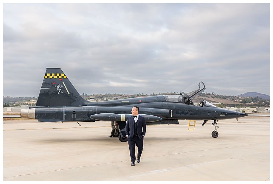 groom walking in front of jet fighter san diego