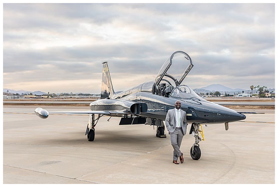 groomsman staning in front of jet at portrait session