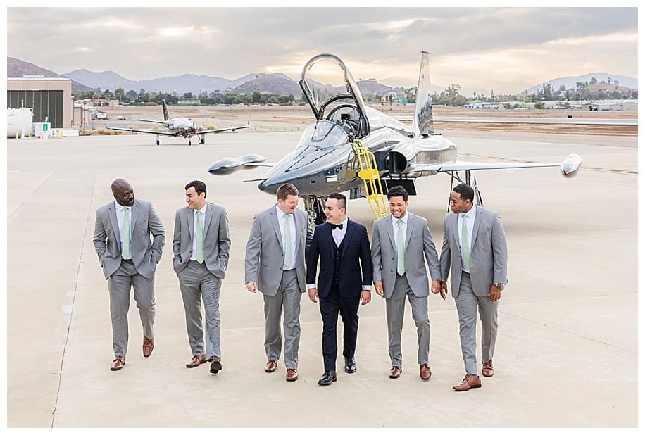 groom and groomsmen walking in front of jet fighter san diego