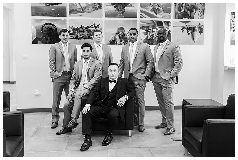 groom and groomsmen sittingin airport lobby
