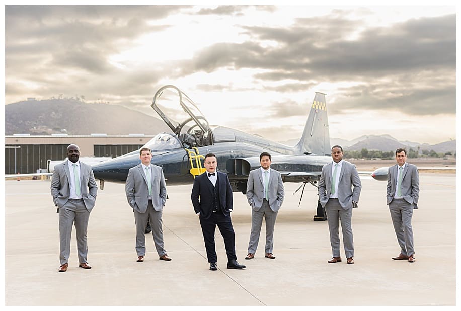 groom and groomsne standing in front of jet fighter san diego