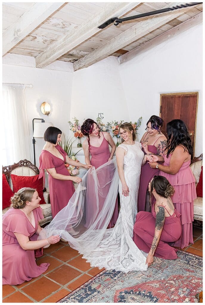 bridesmaid helping bride get ready for her Leo Carrillo wedding