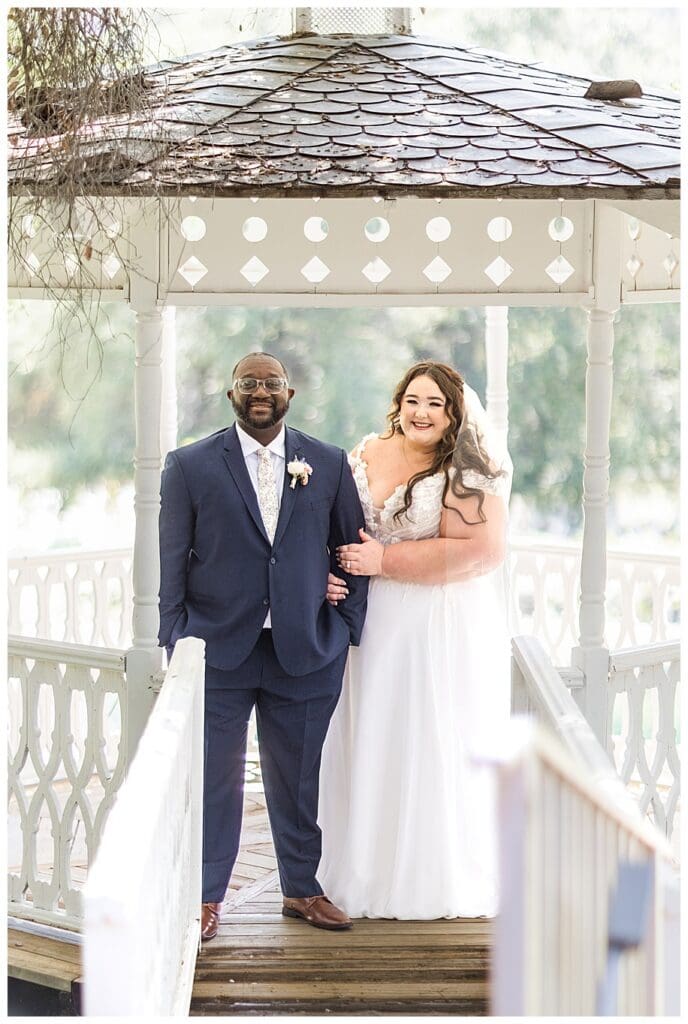 bride and groom standing in front of gazebo at their Enchanted Hills Estate Wedding