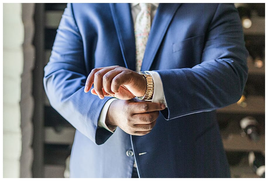 groom adjusting shirt sleeves
