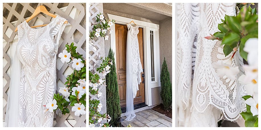 lace wedding dress hanging from door